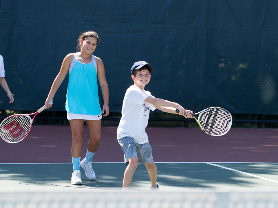 boy and girl doubles tennis match